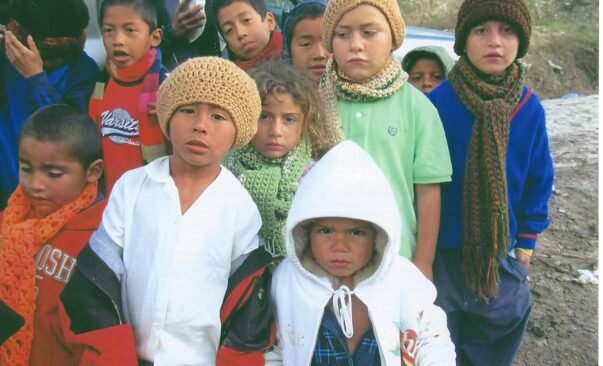 Children receive scarves from the Casa de los Pobres