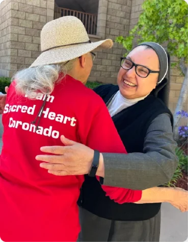 Sister Guadalupe from Casa de los Pobres greets a volunteer from Sacred Heart Parish Coronado