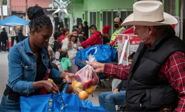 People in Tijuana bring a bag once a week to pick up food.