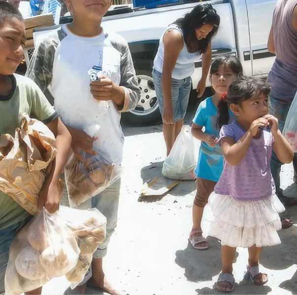 Children receive food from the Casa de los Pobre in Tijuana Mexico