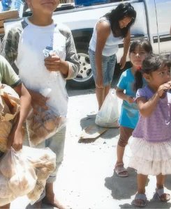 Children receive food from the Casa de los Pobre in Tijuana Mexico