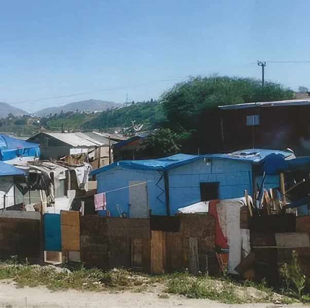 Cardboard shacks with tarps to keep out the rain in Tijuana Mexico
