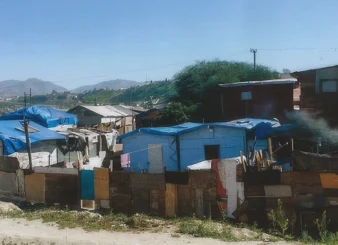 Cardboard shacks with tarps to keep out the rain in Tijuana Mexico