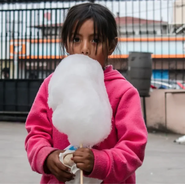 A child with cotton candy at the Casa de los Pobres in Tijuana Mexico