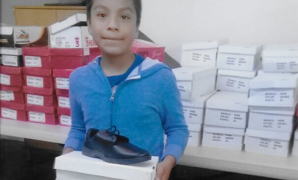 Boy gets new shoes at Casa de los Pobres, Tijuana, Mexico